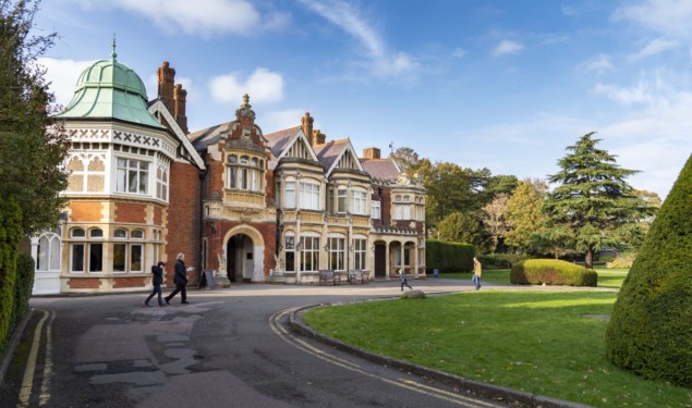 Bletchley Park Mansion, a brick building with many turrets and windows, under a blue sky