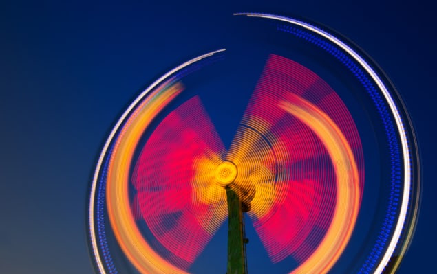 A photograph of a fairground at night