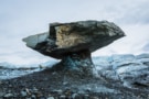 Photo of a glacier table - a rock balanced on a column of ice