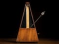 A photo of a metronome showing the weight and pendulum