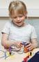 A young child working with simple electronics