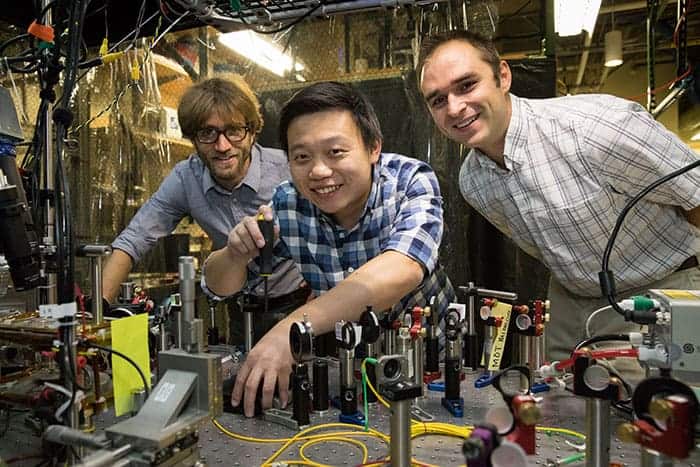 Photograph of Wesley Campbell, Xueping Long and Andrew Jayich in the lab at UCLA