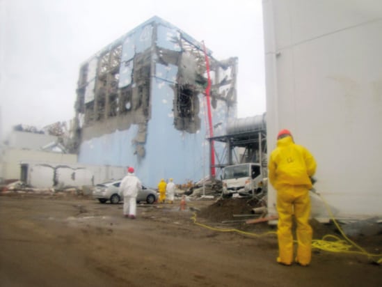 Photograph of workers outside the damaged unit 4 reactor building