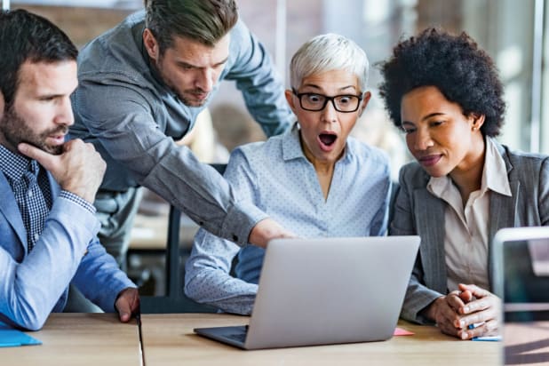 Group of businesspeople looking shocked