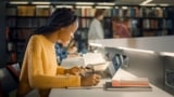 Photo of woman scientist working on peer review on a laptop